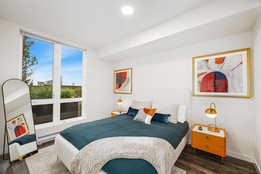 a bedroom with a bed and a large window