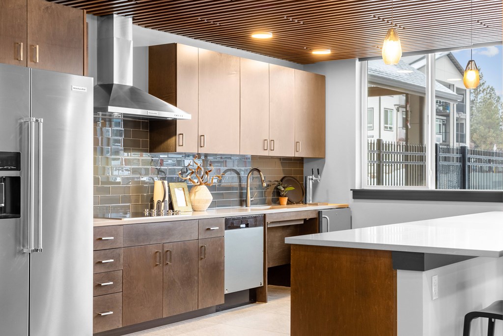 A modern kitchen with wooden cabinets and a white countertop.