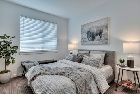 a bedroom with a bed and a painting of a cow
