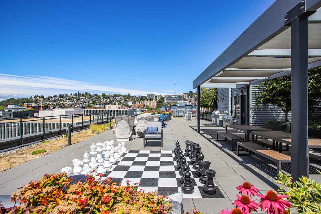 a chess board on a patio with a view of the city