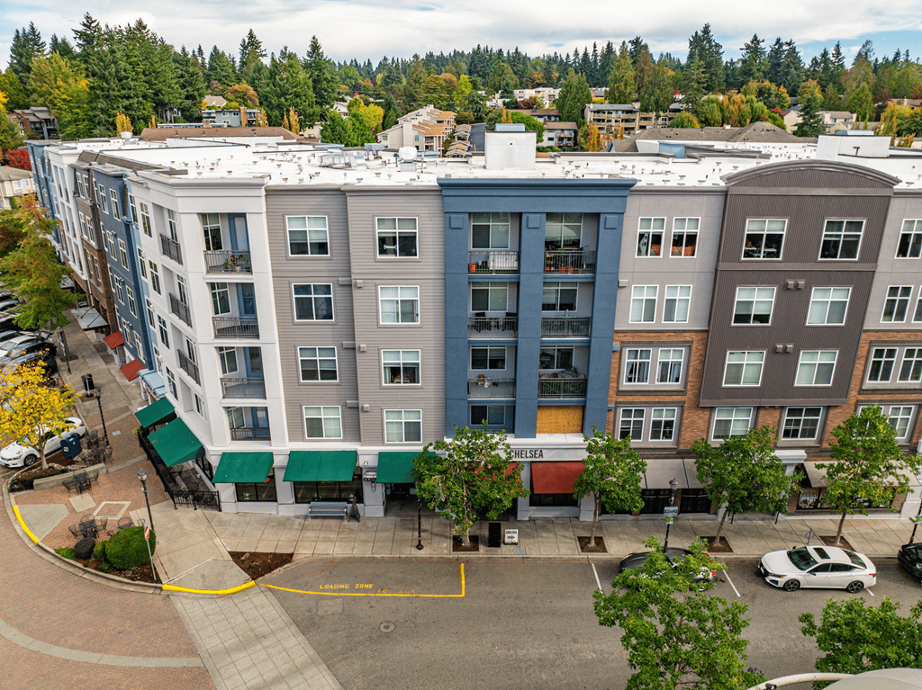 A parking lot in front of a building with a yellow circle drawn on it.