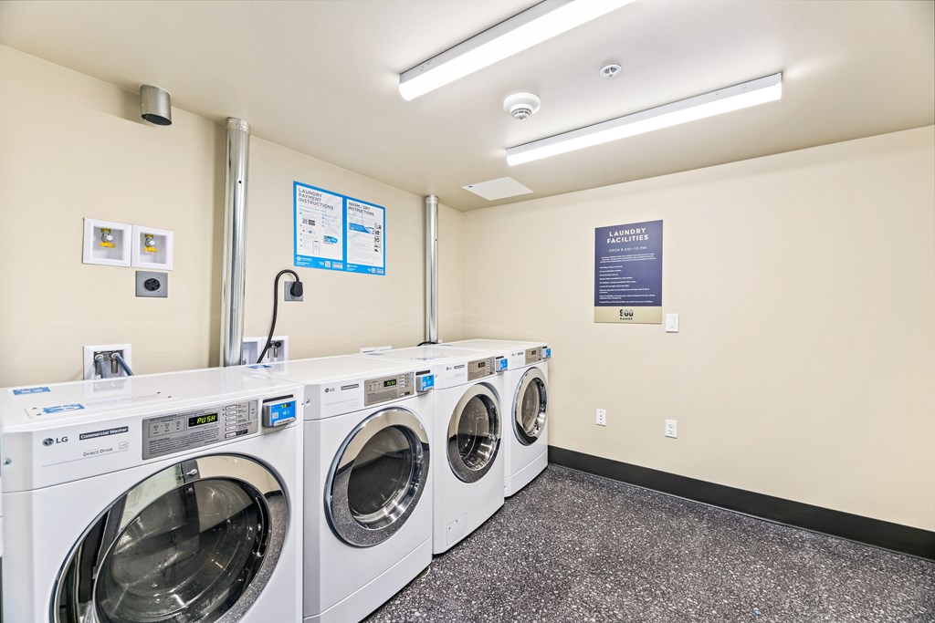 A row of washing machines in a laundromat.