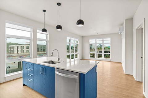A kitchen with blue cabinets and a white countertop.
