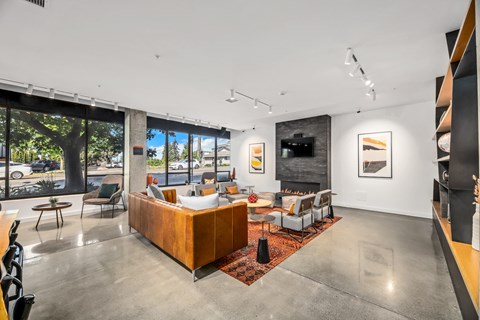 a living room with a couch and chairs and a fireplace