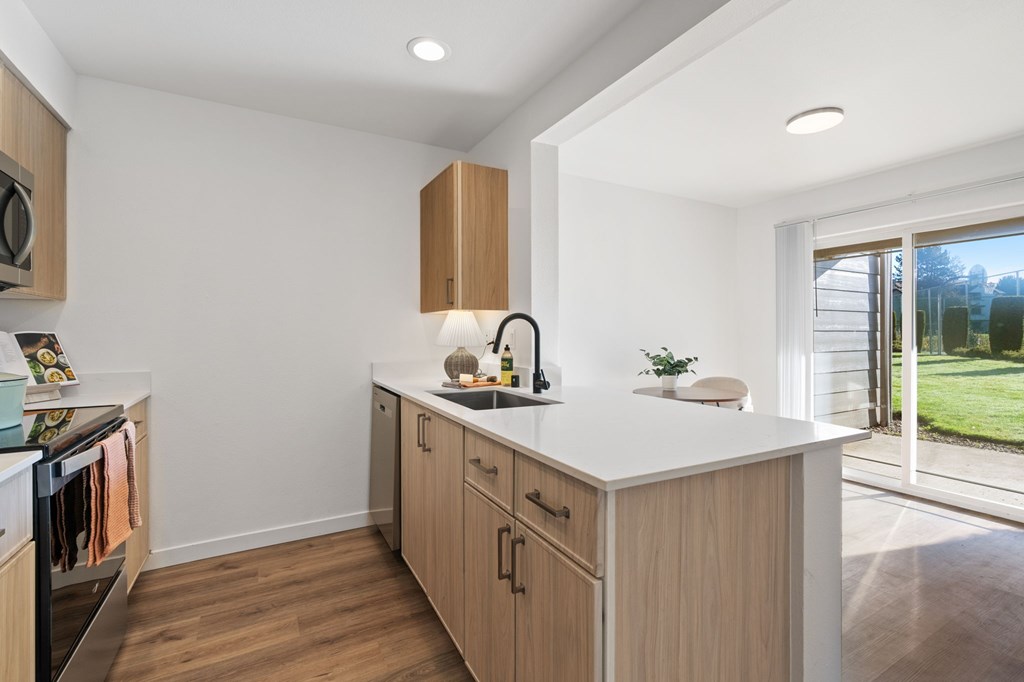 A kitchen with wooden cabinets and a white countertop.