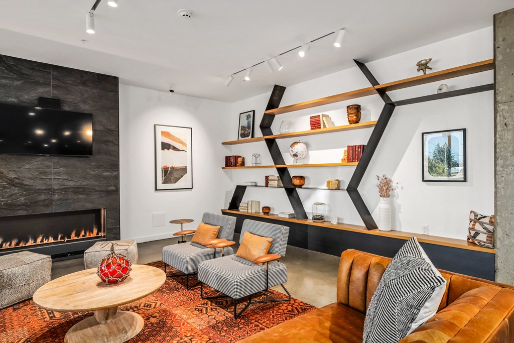 a living room with couches and chairs and a fireplace