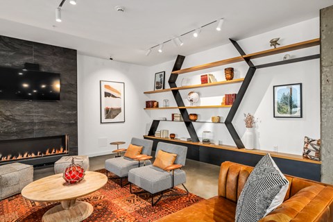 a living room with couches and chairs and a fireplace