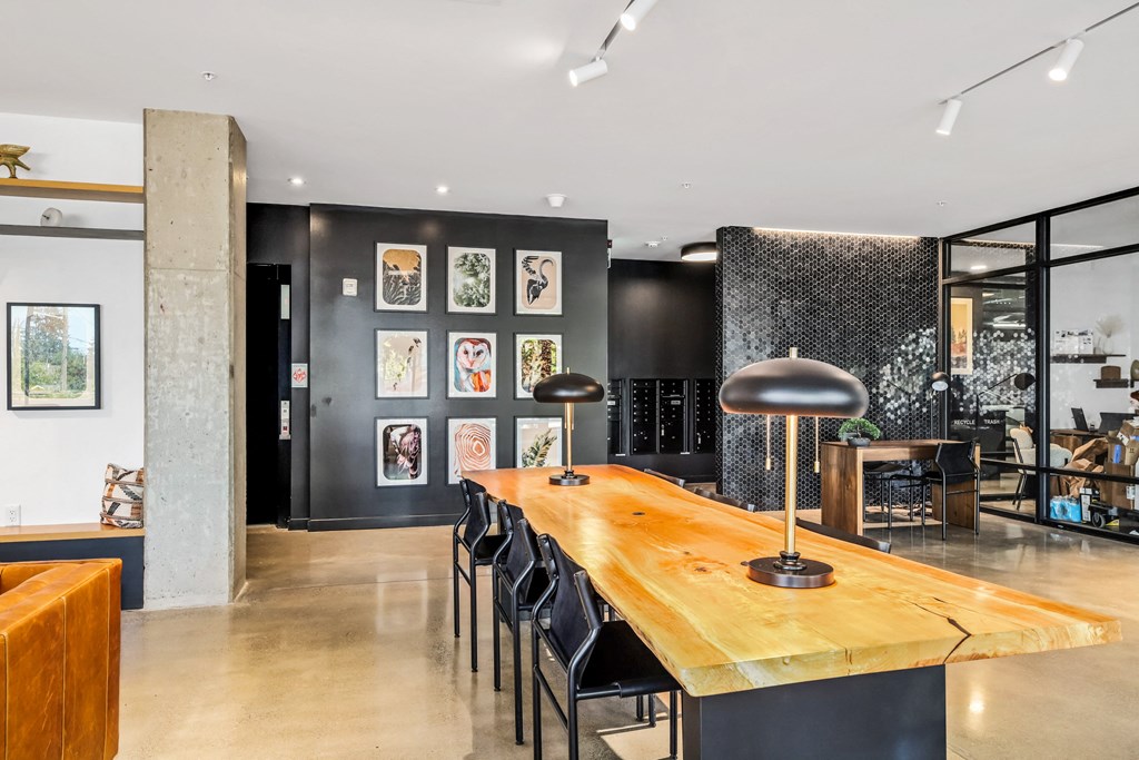 a dining room with a wooden table and black chairs