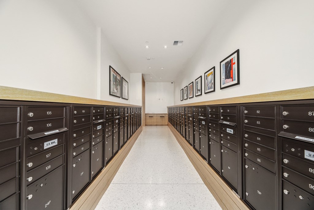 a long hallway with rows of mailboxes in a building