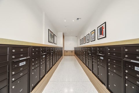 a long hallway with rows of mailboxes in a building