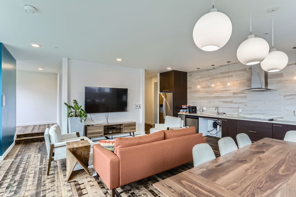 A modern living room with a wooden table and orange sofa.