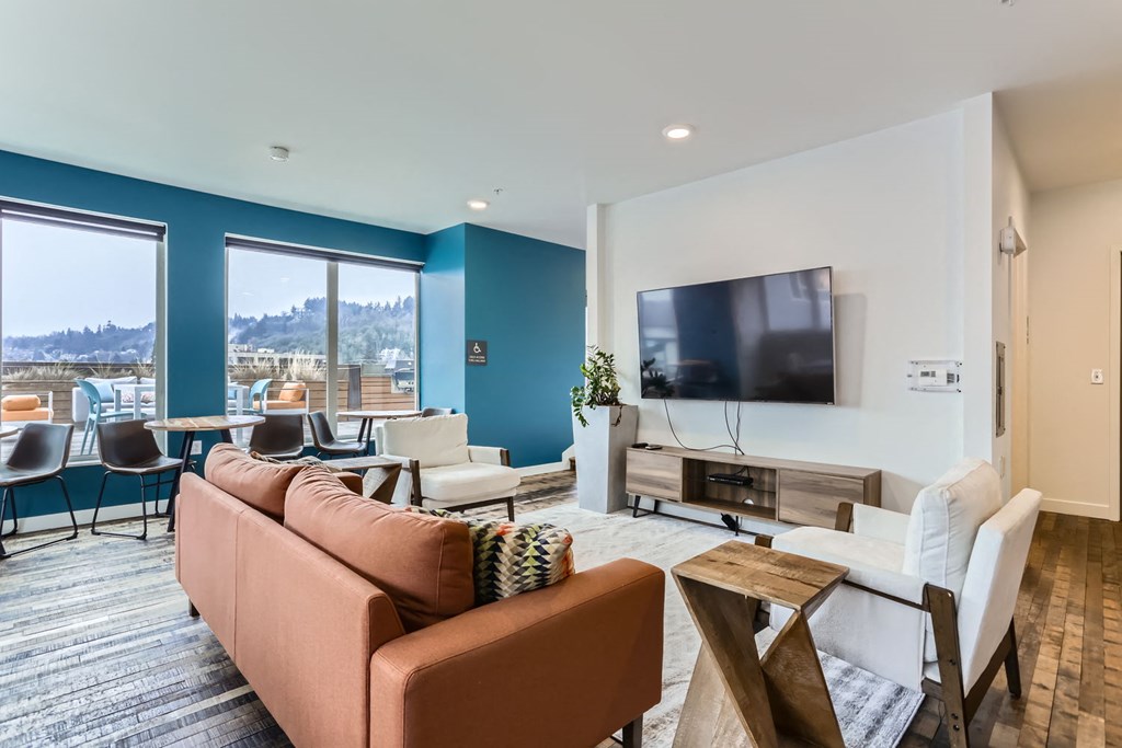 A living room with a brown couch and a television.