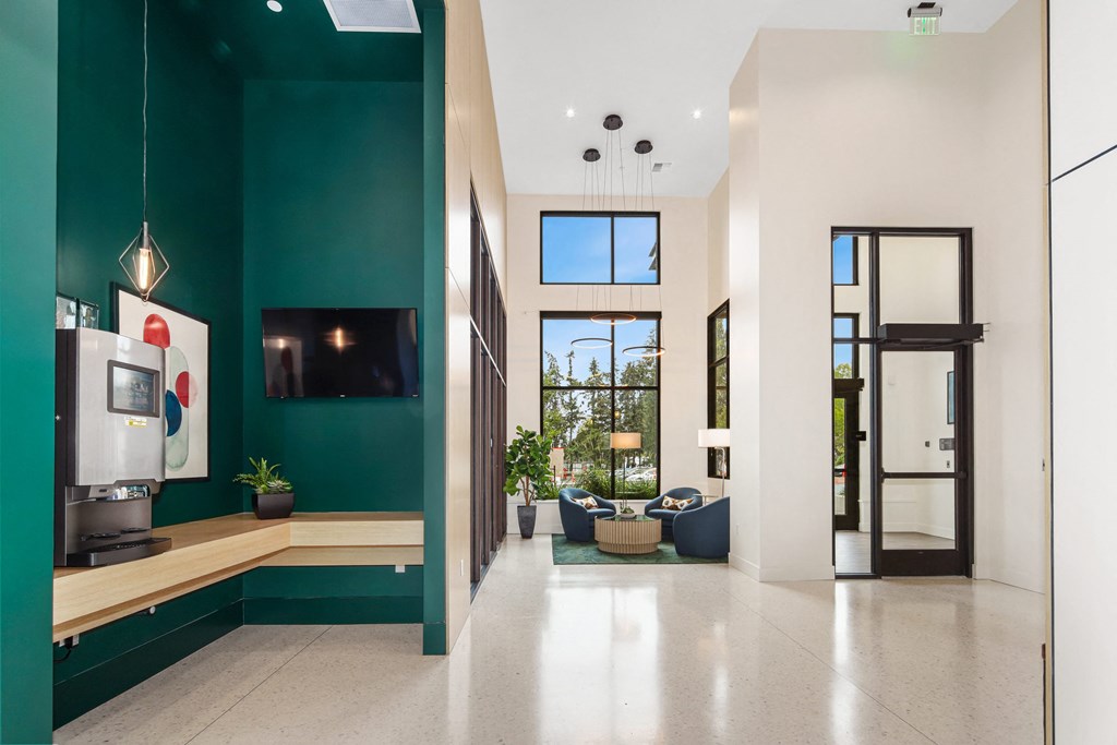 a living room with a green wall and a tv in it