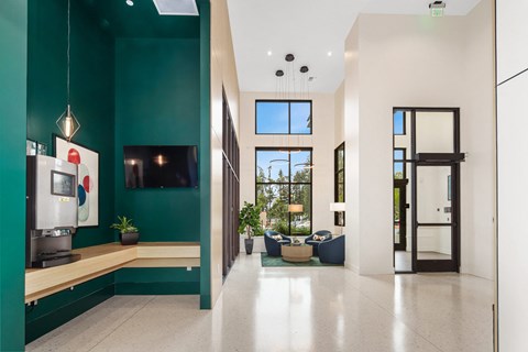 a living room with a green wall and a tv in it