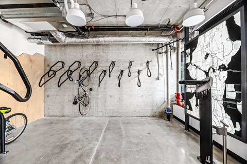 a room with bikes hanging on the wall and a map on a wall