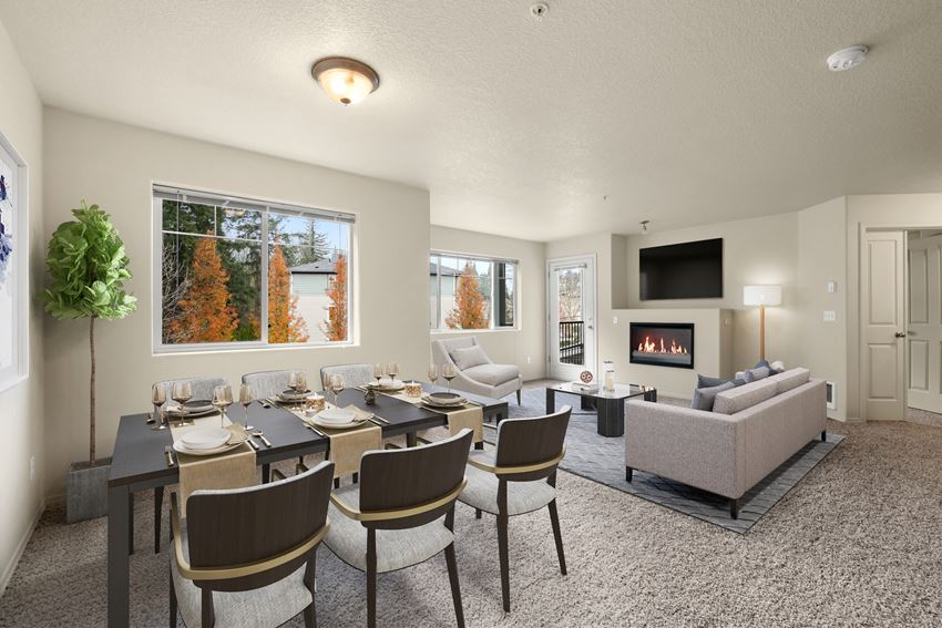 a living room with a table and chairs and a fireplace