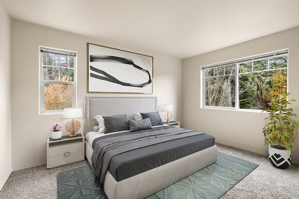 a bedroom with a bed and two windows