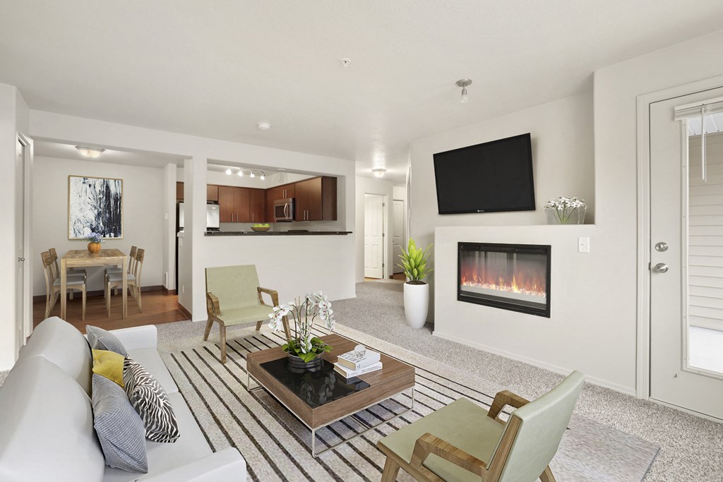 a living room with a couch and a coffee table and a fireplace