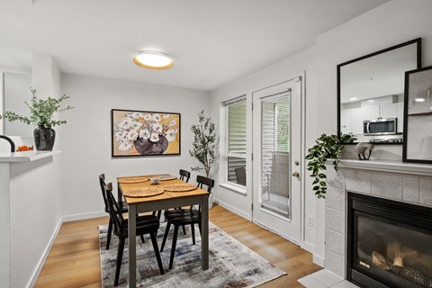 A dining room with a table and chairs.