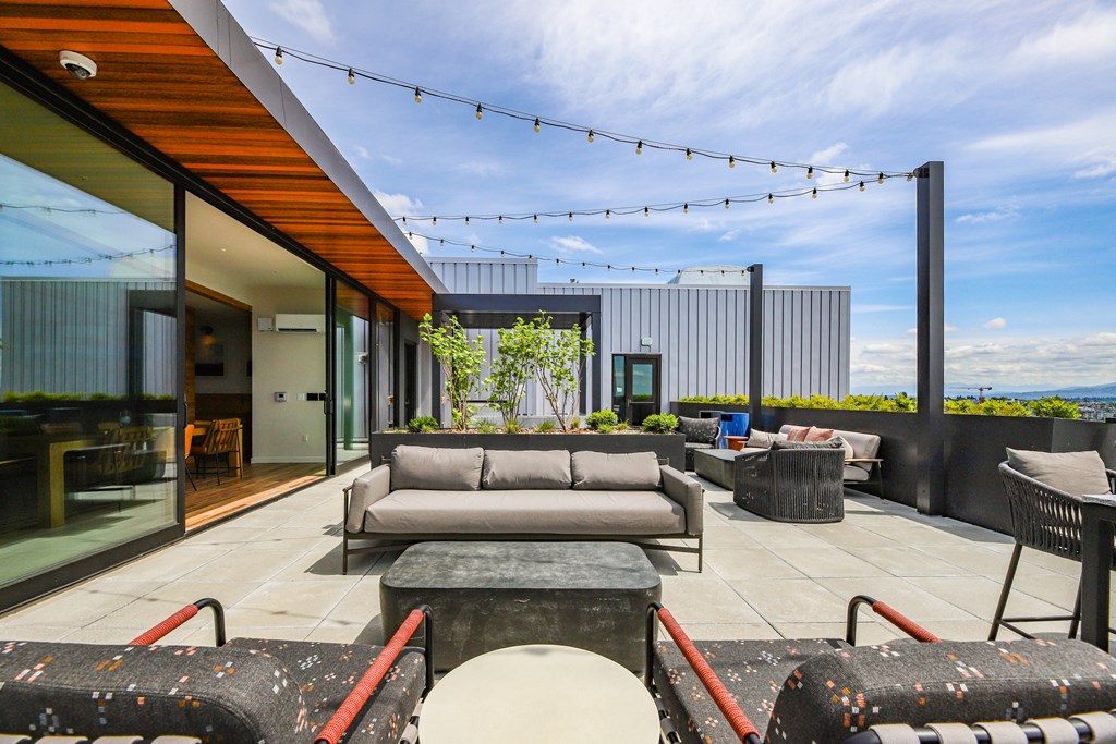 A modern outdoor seating area with a view of the city.