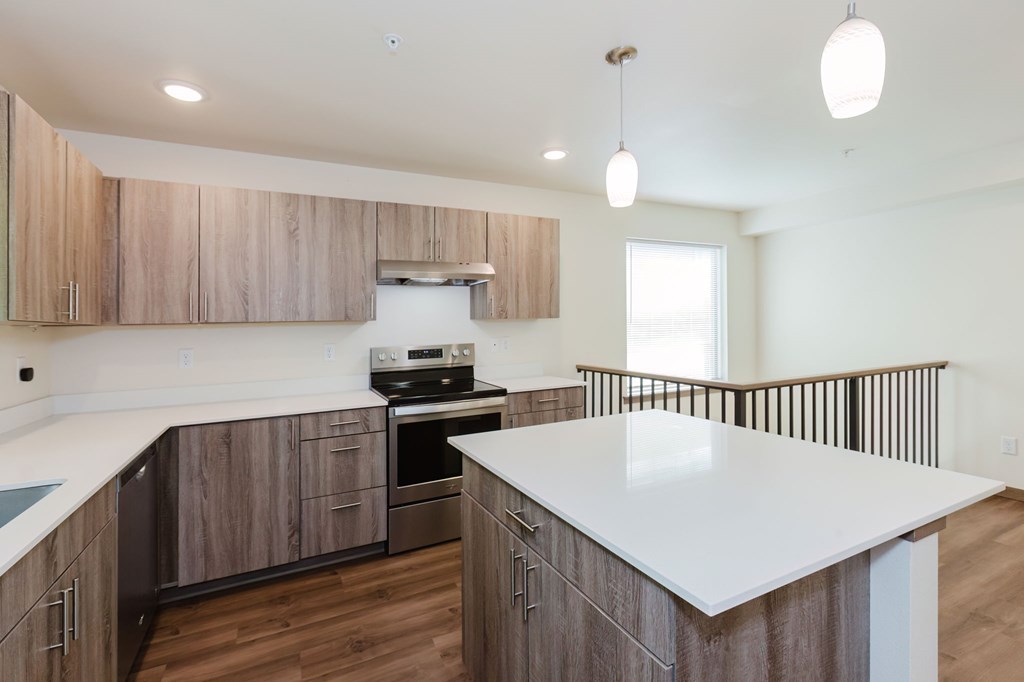 A modern kitchen with wooden cabinets and a white countertop.