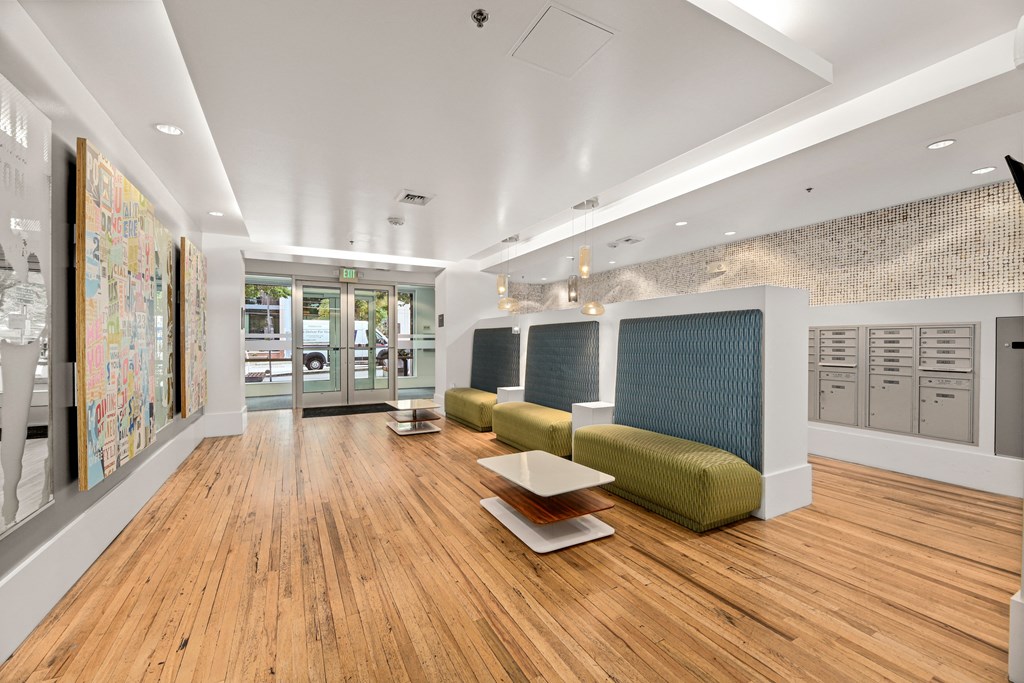a lobby of a building with couches and a table