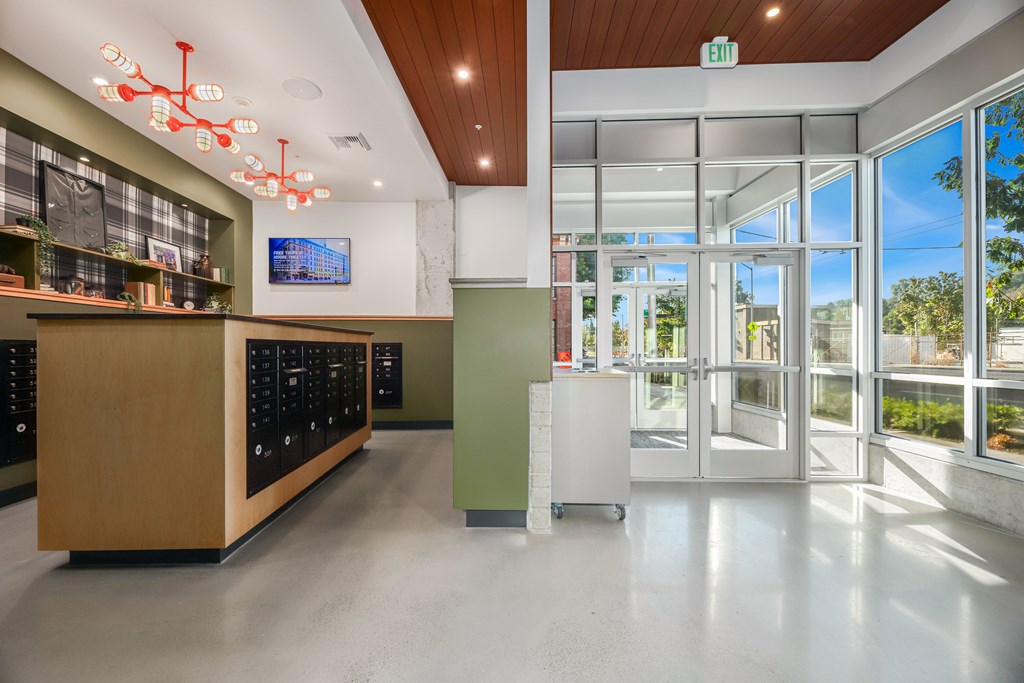 A modern interior with a wooden counter and a green trash bin.