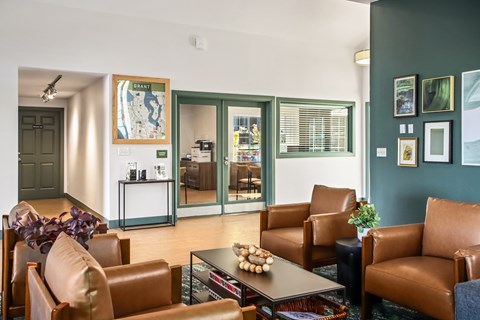 A living room with brown leather chairs and a coffee table.