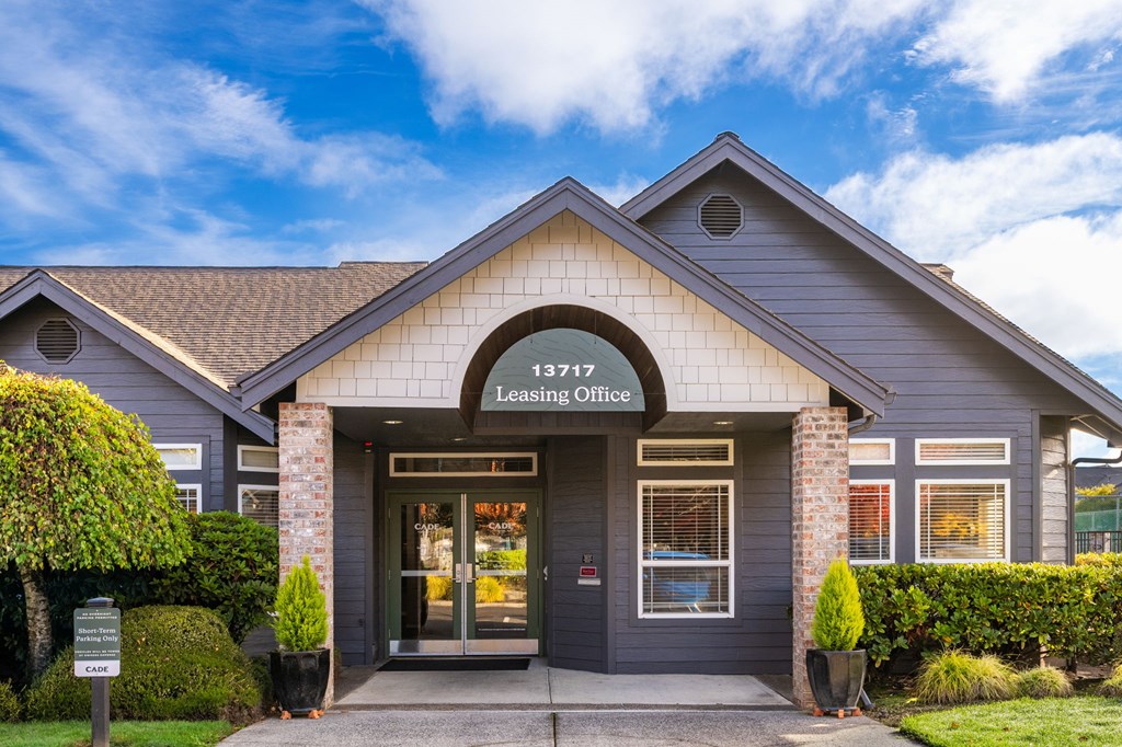 The front of a building with a sign that says Leasing Office.
