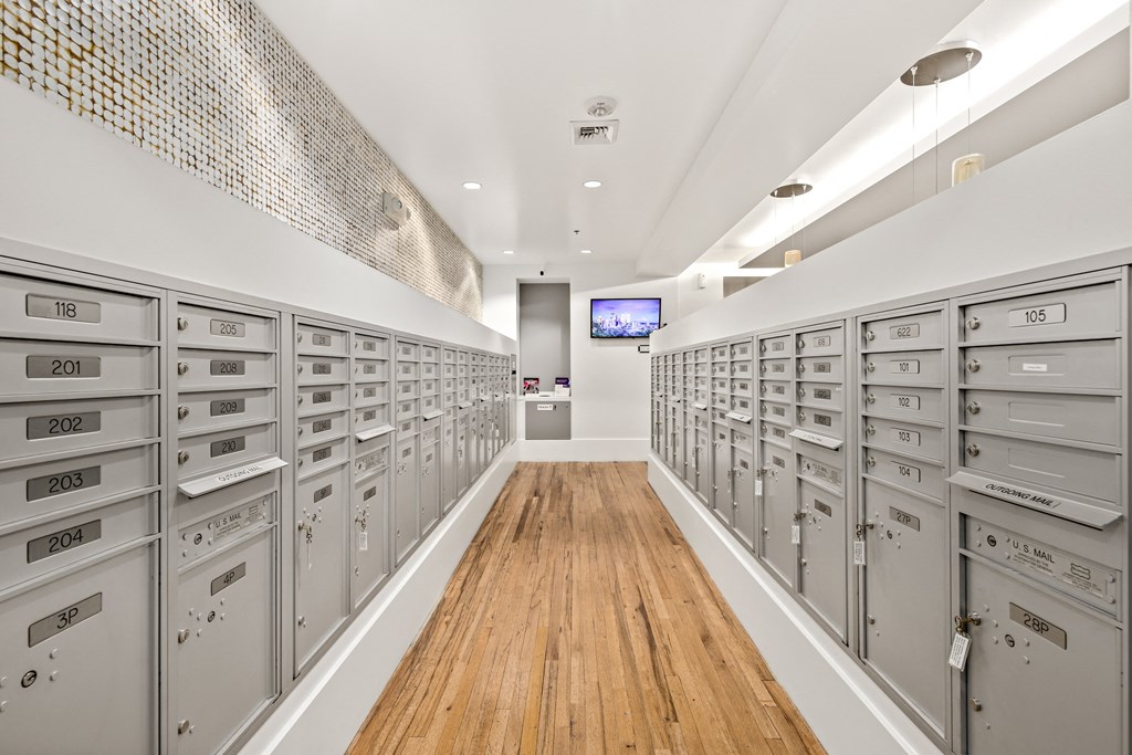 a long room with many filing cabinets and a television in the back