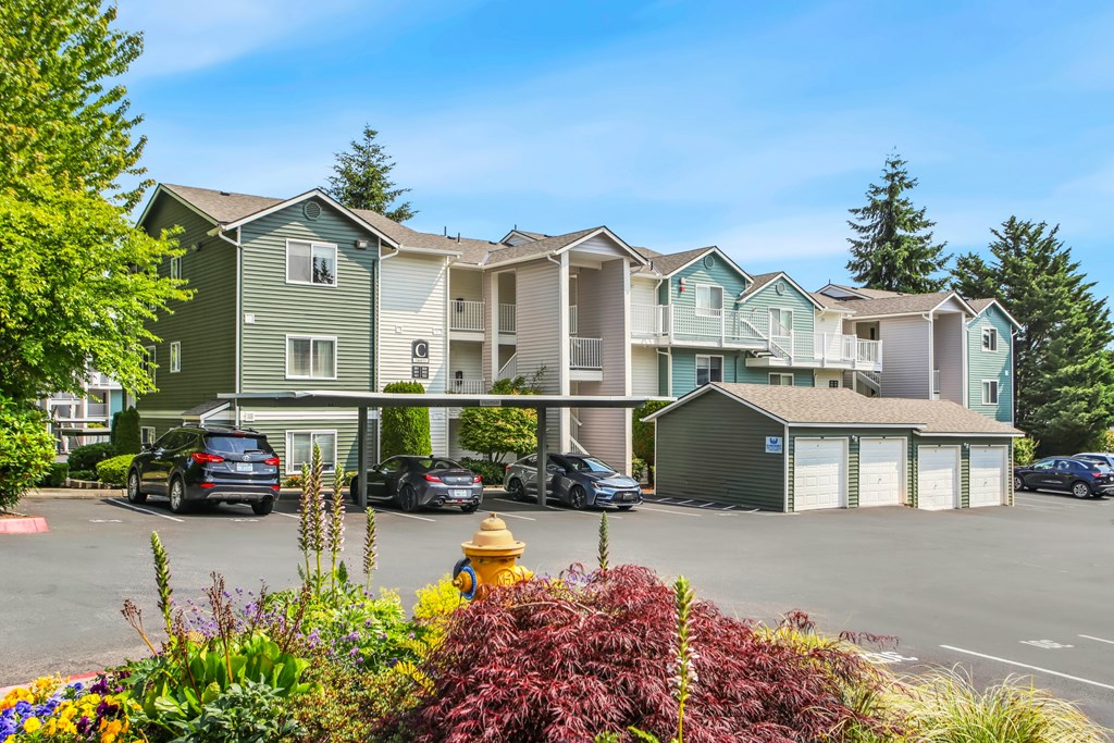 A row of townhouses with a yellow fire hydrant in front.
