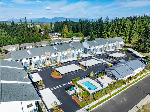A large building complex with a pool in the middle.
