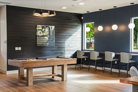 A dining room with a wooden table and chairs.