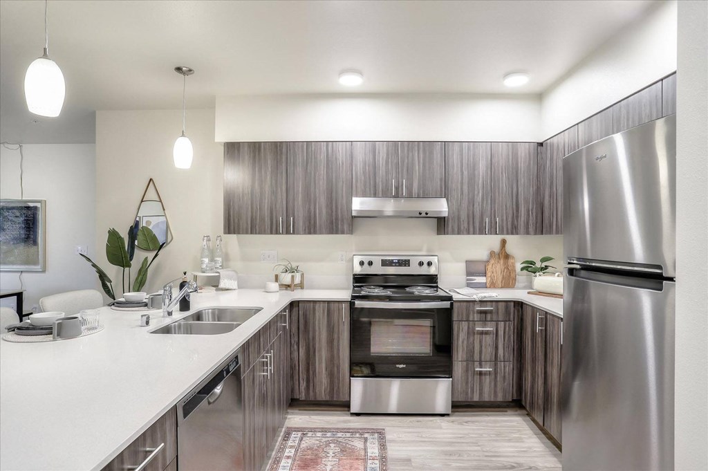 a kitchen with stainless steel appliances and wooden cabinets
