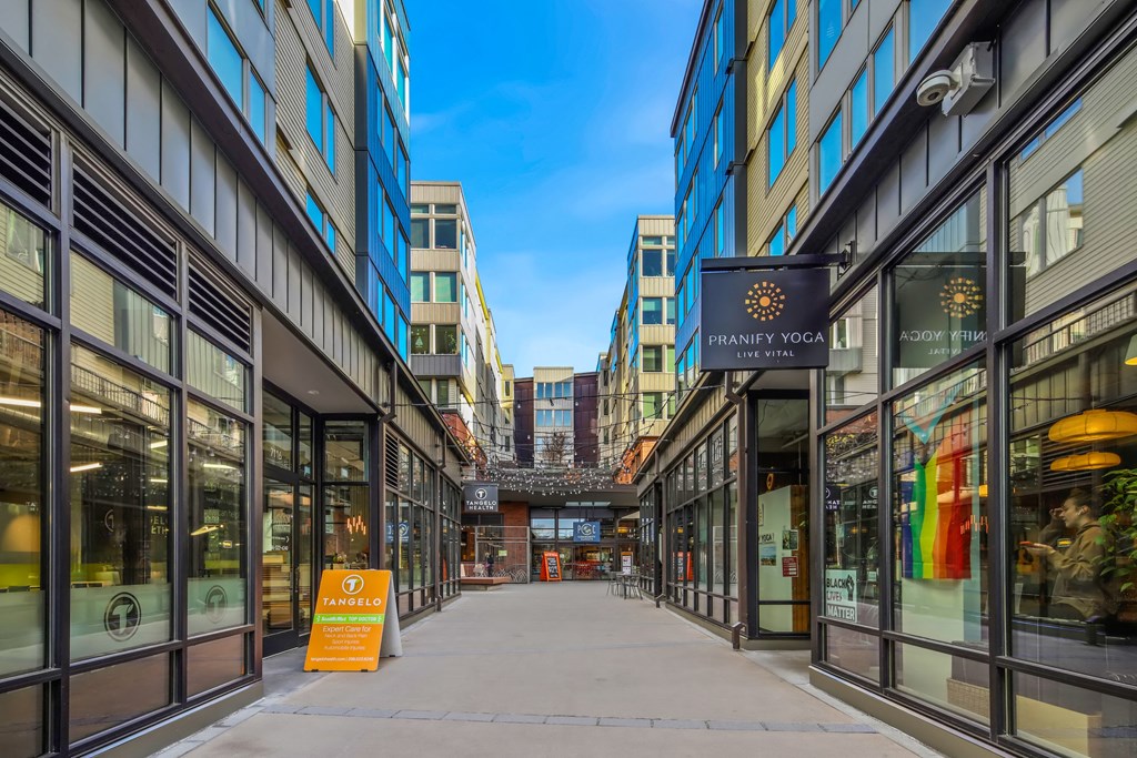A street view of a city with a sign for Haney Yoga.