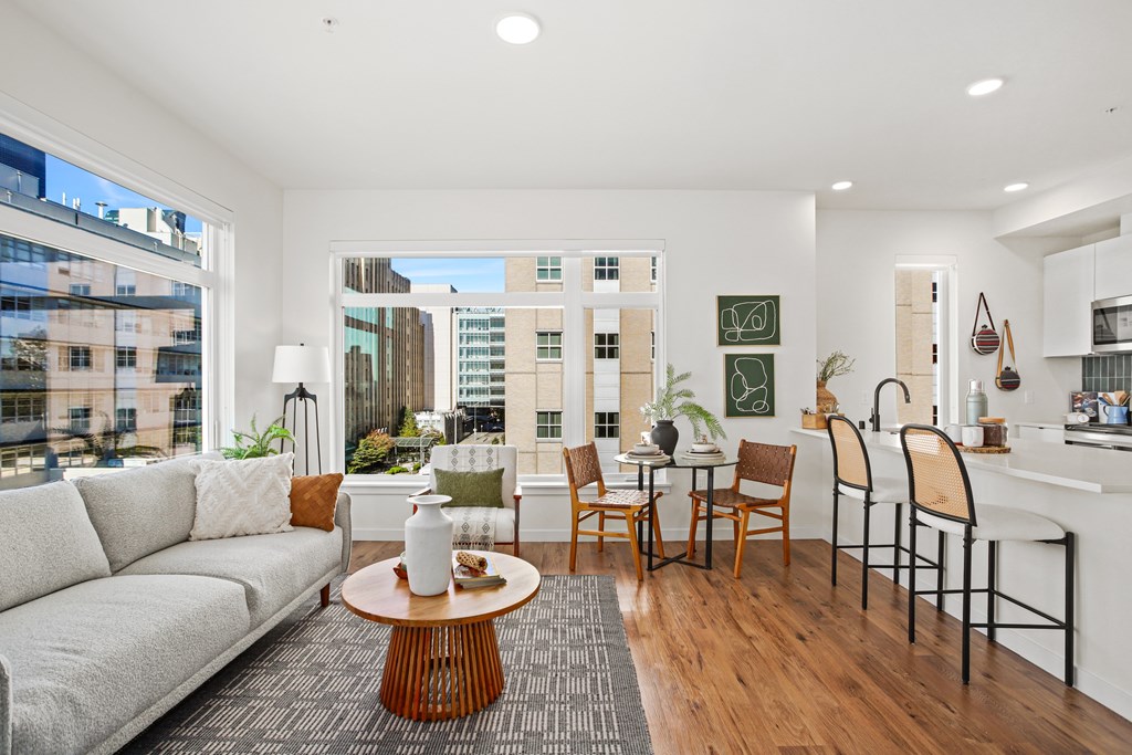 A modern living room with a large window overlooking the city.