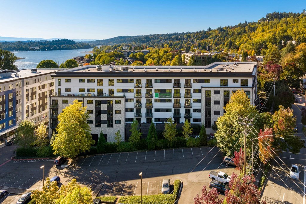 A large white building with a parking lot in front of it.