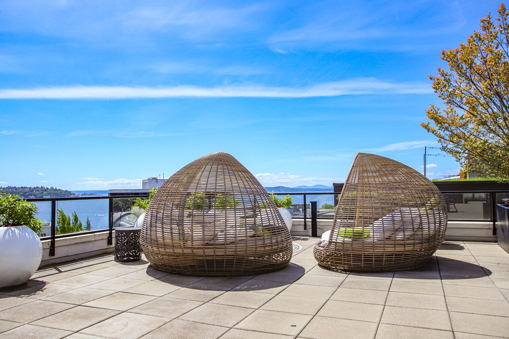 two chairs on a balcony with a view of the water