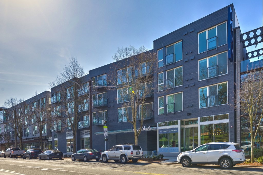 a building with cars parked in front of it on a street