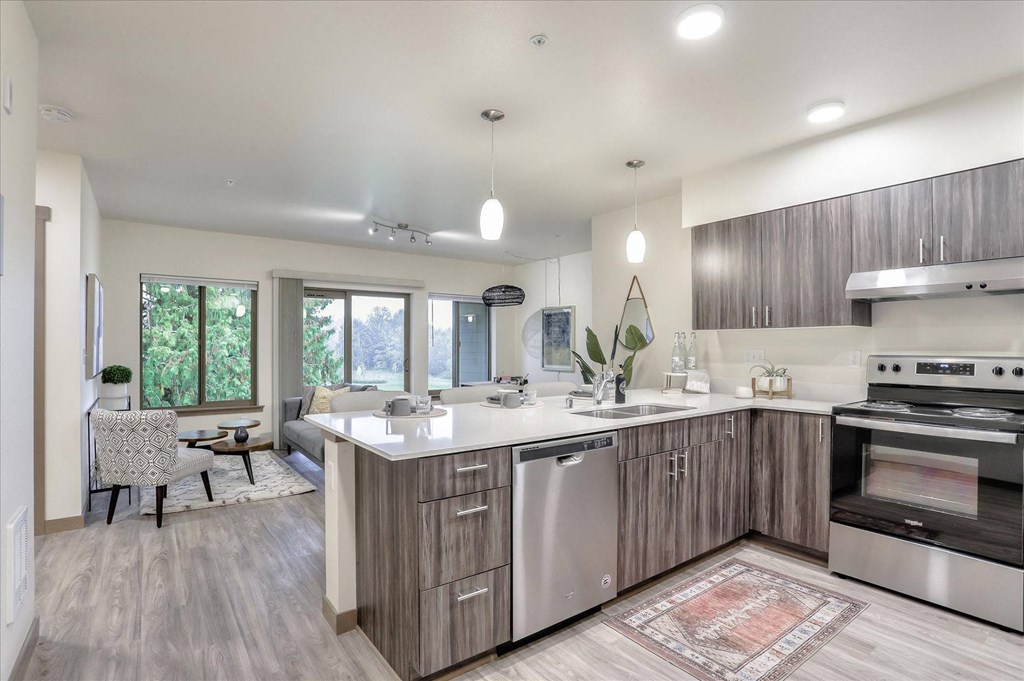 a kitchen with an island and a living room