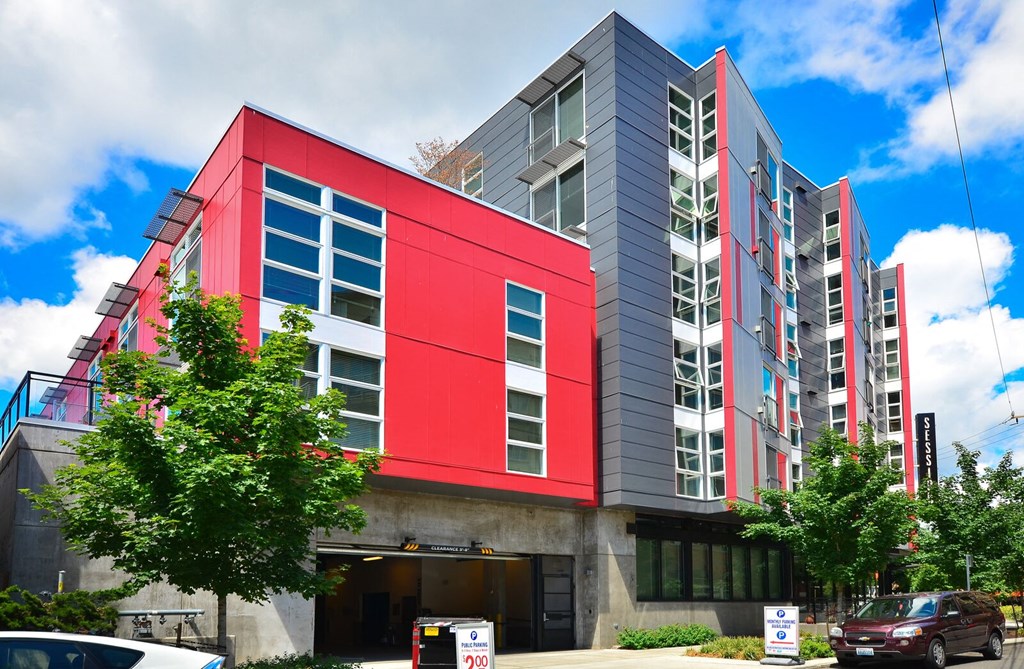 a red and grey building with trees in front of it