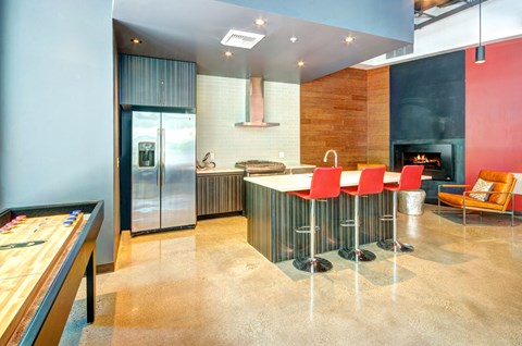 a kitchen with a bar and a table with chairs