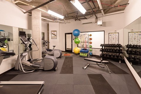 a spacious fitness center with treadmills and other exercise equipment