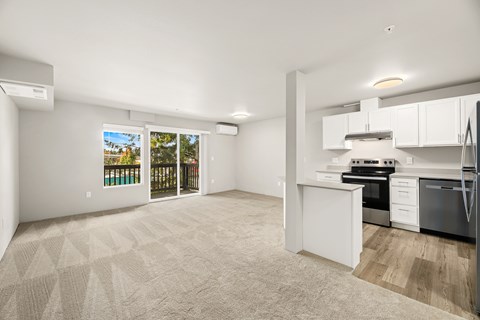 A spacious kitchen with white cabinets and a black stove top oven.