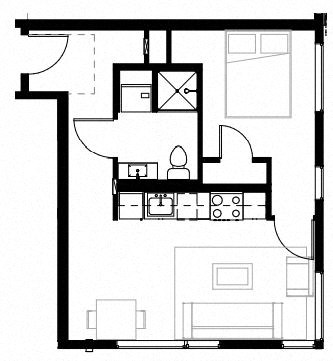 a small room with a bed and a desk