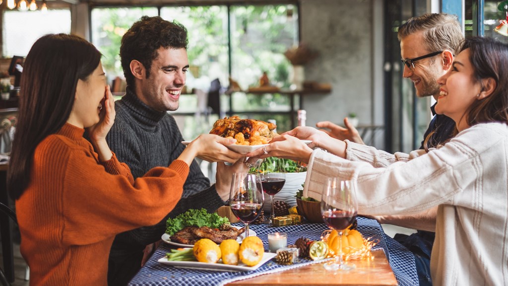 a group of people sitting around a table eating food