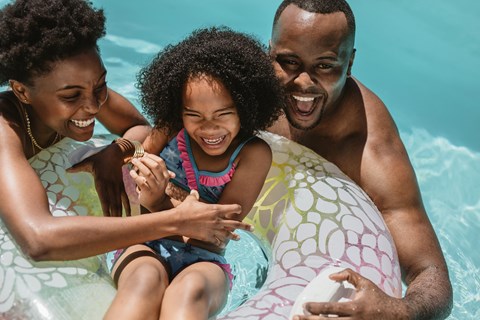 a family playing in a pool