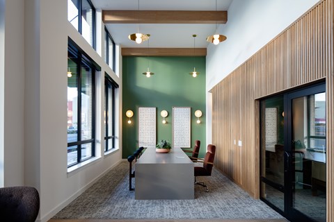 A conference room with a long table and chairs.