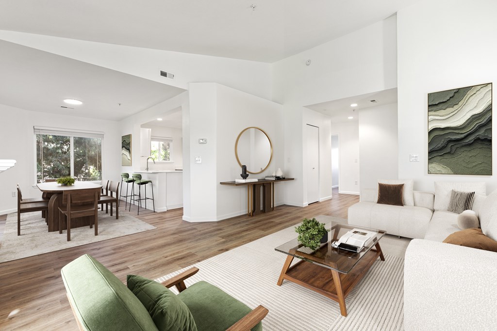 A modern living room with a green couch and a wooden coffee table.