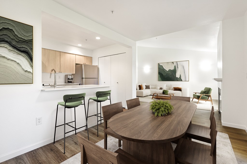 A modern dining room with a wooden table and chairs.